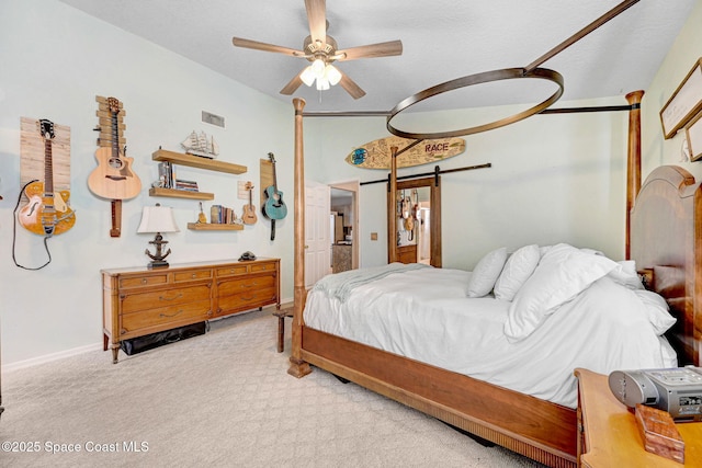 bedroom with vaulted ceiling, a barn door, light carpet, and ceiling fan