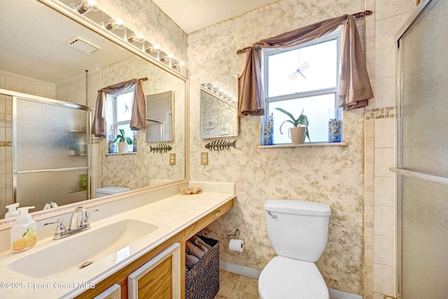 bathroom featuring vanity, an enclosed shower, and toilet