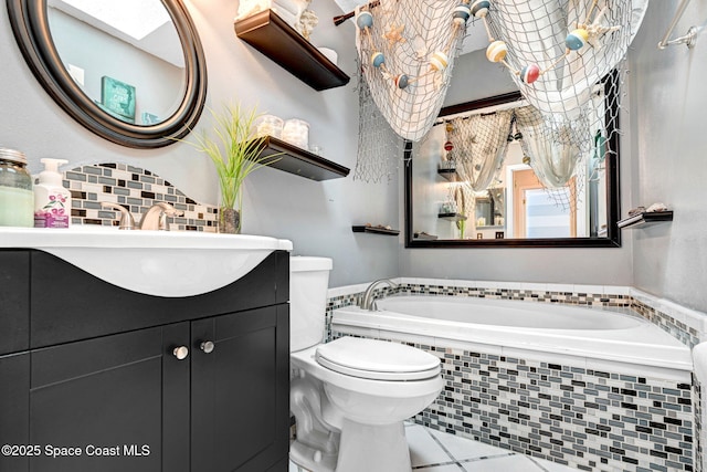 bathroom with decorative backsplash, tile patterned flooring, vanity, toilet, and tiled tub