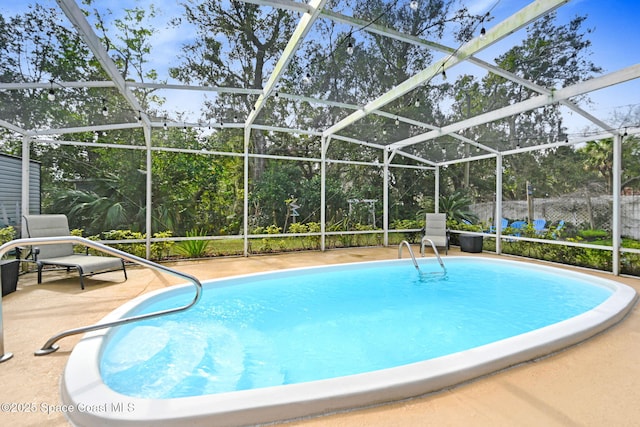 view of swimming pool with a patio and glass enclosure