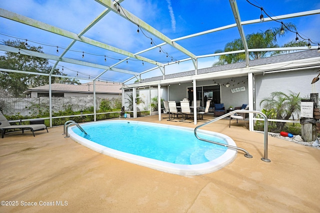 view of pool with a lanai and a patio area