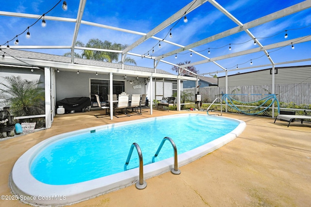 view of swimming pool with a patio area and glass enclosure