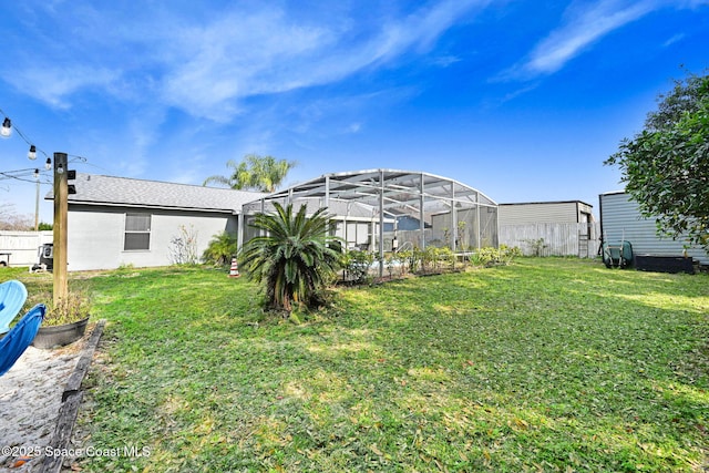 view of yard with glass enclosure