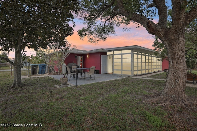 exterior space with a patio and a lawn