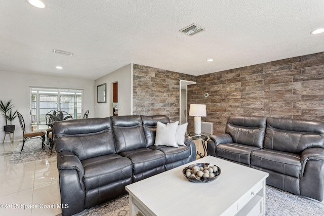 tiled living room featuring a textured ceiling