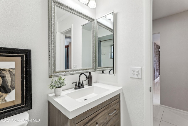 bathroom featuring tile patterned flooring and vanity