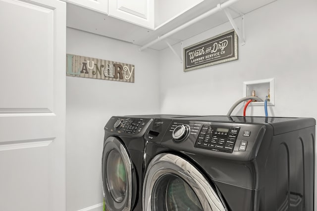 laundry room with cabinets and washer and dryer