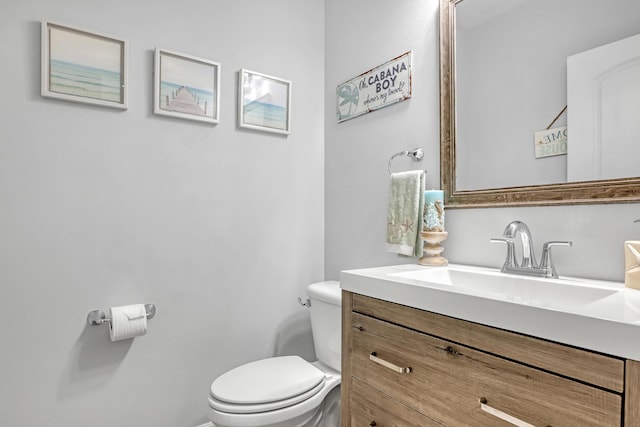 bathroom featuring vanity and toilet