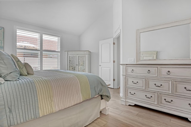 bedroom with lofted ceiling and light wood-type flooring