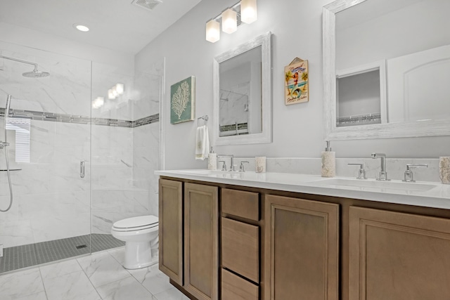 bathroom with vanity, toilet, and a shower with door