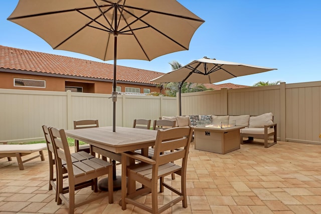 view of patio featuring an outdoor living space with a fire pit