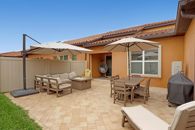 view of patio featuring area for grilling and an outdoor living space with a fire pit