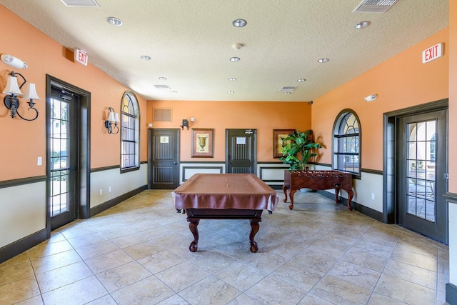 recreation room featuring pool table and a textured ceiling