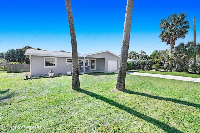 ranch-style home with a garage and a front yard