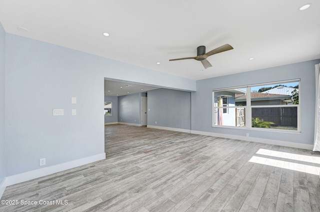 empty room featuring ceiling fan and light hardwood / wood-style floors