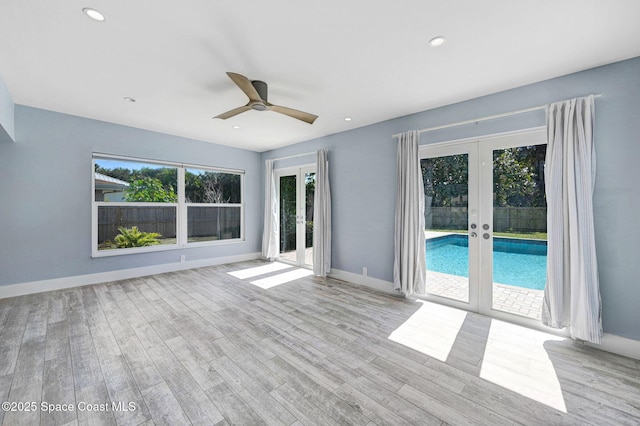 unfurnished living room featuring light hardwood / wood-style floors, french doors, and ceiling fan