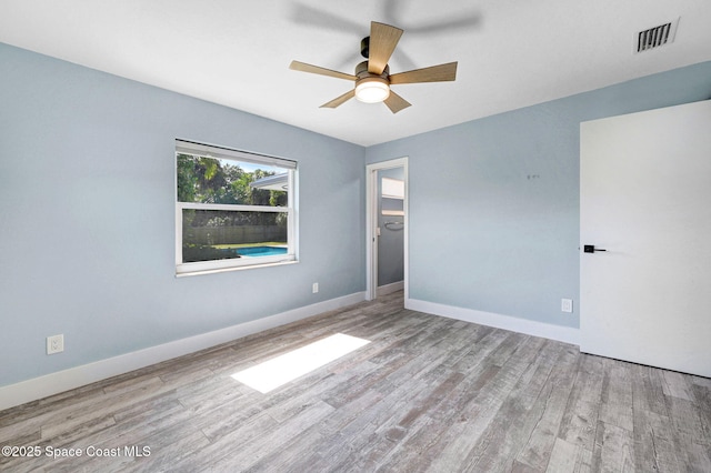 spare room featuring light hardwood / wood-style flooring and ceiling fan