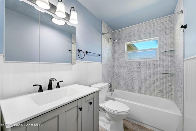 full bathroom with vanity, tiled shower / bath combo, wood-type flooring, and toilet