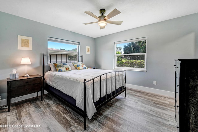 bedroom with hardwood / wood-style floors and ceiling fan