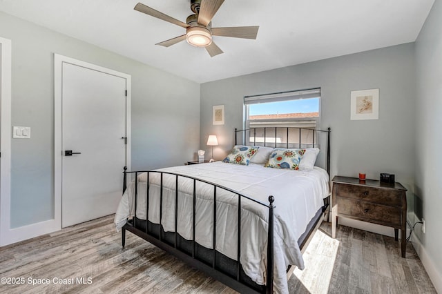 bedroom with hardwood / wood-style flooring and ceiling fan