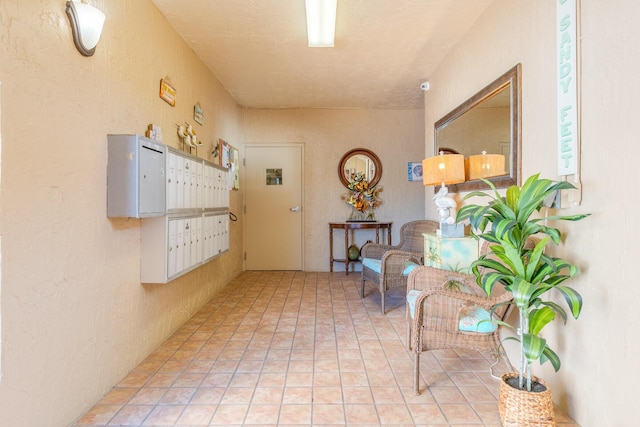 hall with mail boxes and light tile patterned flooring