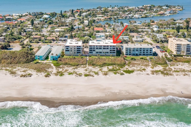 aerial view with a water view and a view of the beach