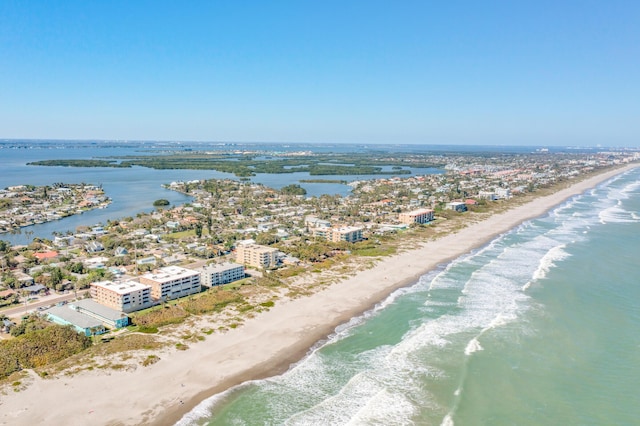 aerial view with a water view and a view of the beach