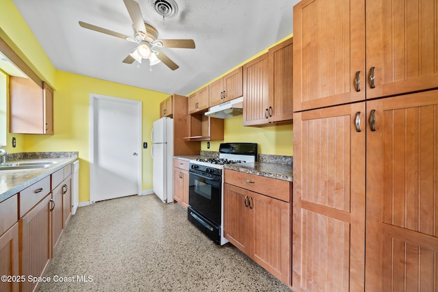 kitchen with ceiling fan, black range with gas cooktop, sink, and white fridge