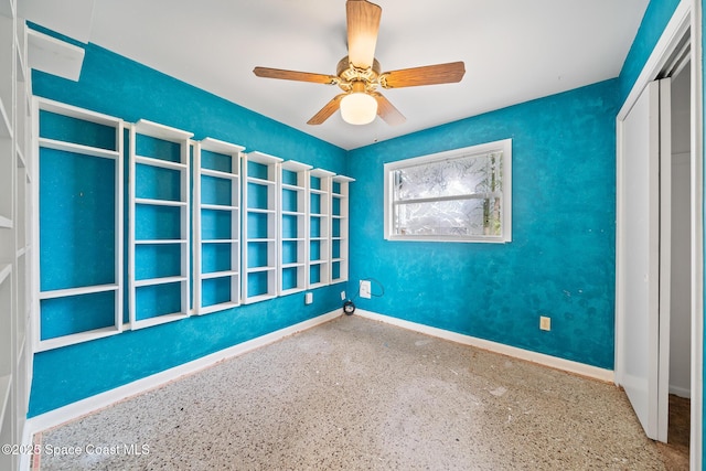 interior space with ceiling fan