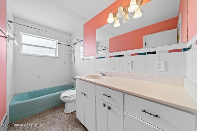 full bathroom with vanity, toilet, tiled shower / bath combo, and tile walls