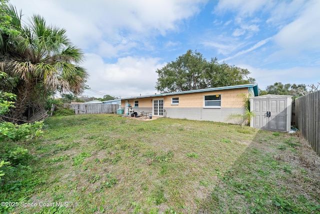 back of property featuring a yard and a shed