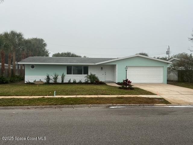 ranch-style house with a garage and a front lawn