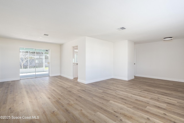 unfurnished room with light wood-type flooring