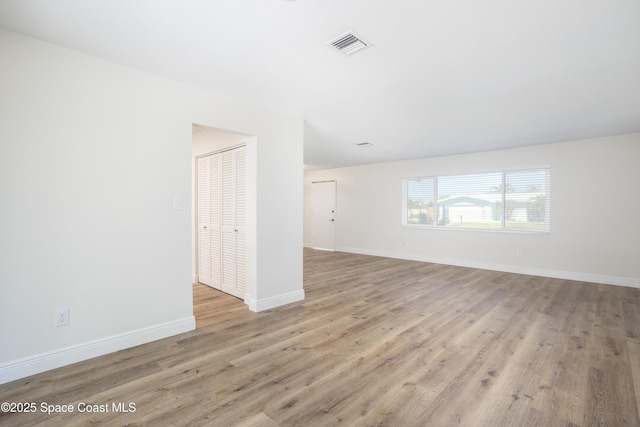 unfurnished room with light hardwood / wood-style flooring