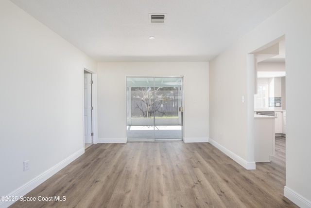 empty room featuring a healthy amount of sunlight and light wood-type flooring