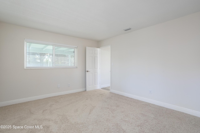 empty room featuring light colored carpet