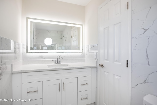 bathroom with tile walls, toilet, and vanity