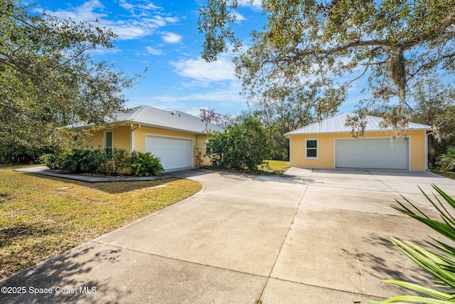 view of front of property featuring a garage and a front lawn