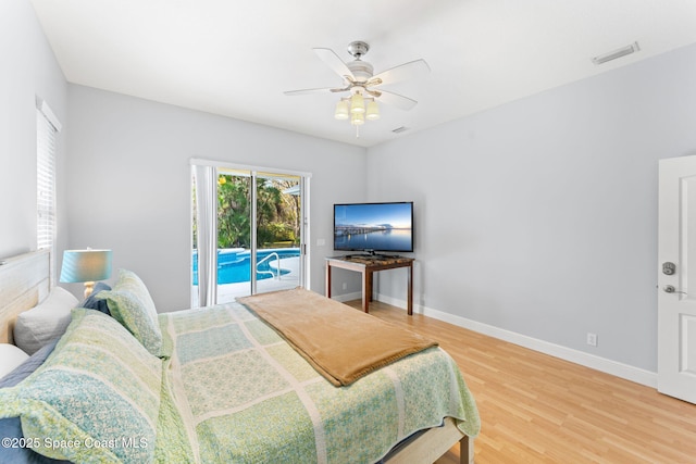 bedroom with hardwood / wood-style flooring, ceiling fan, and access to exterior