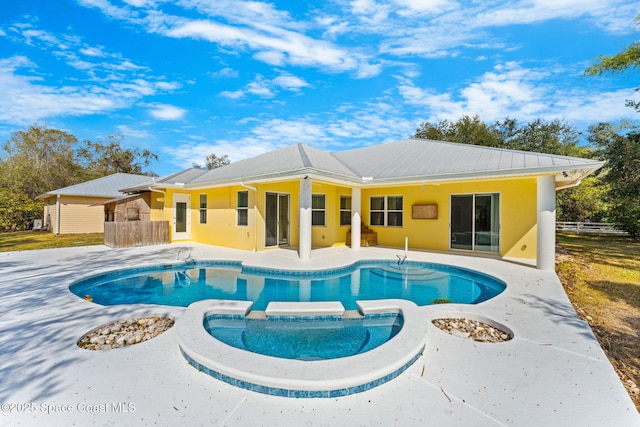 view of pool with a patio and an in ground hot tub