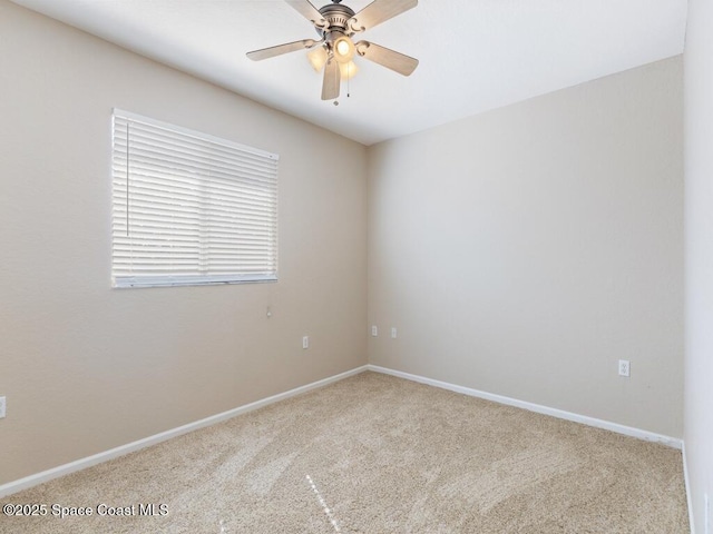 carpeted spare room featuring ceiling fan