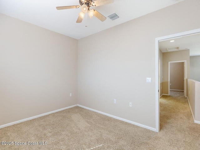 unfurnished room featuring light carpet and ceiling fan