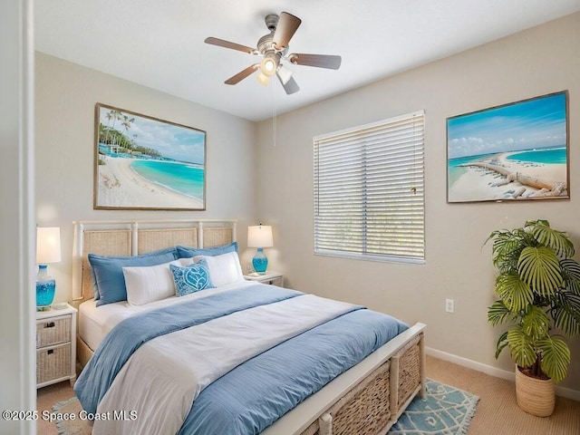 bedroom featuring light colored carpet and ceiling fan