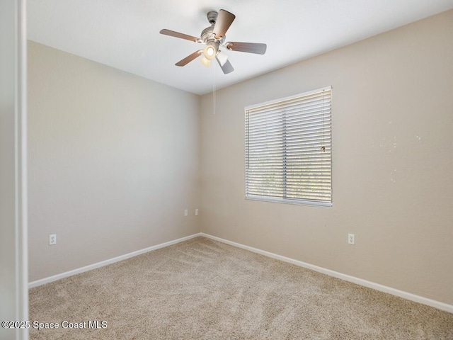 empty room with ceiling fan and light colored carpet