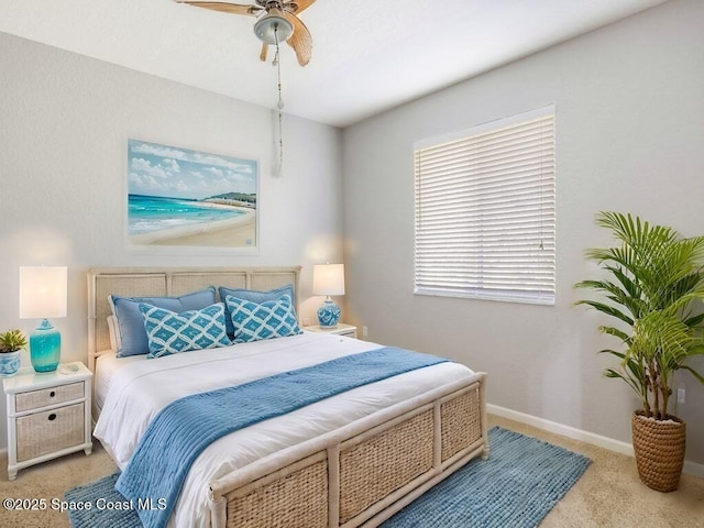 bedroom with light carpet and ceiling fan