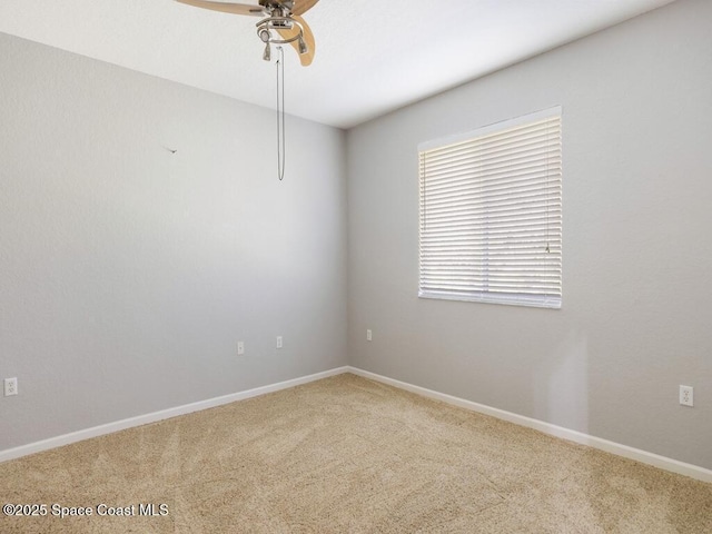 spare room featuring ceiling fan and carpet