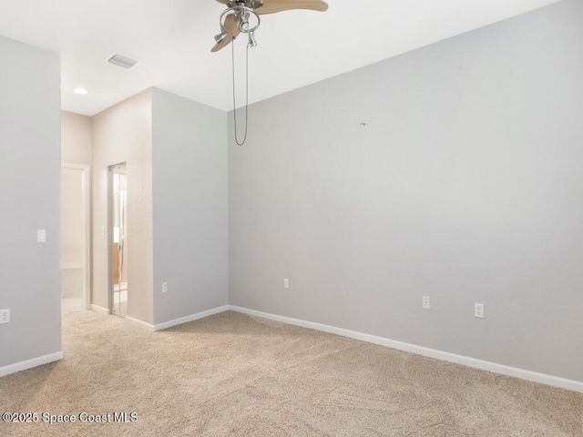 spare room featuring light carpet and ceiling fan