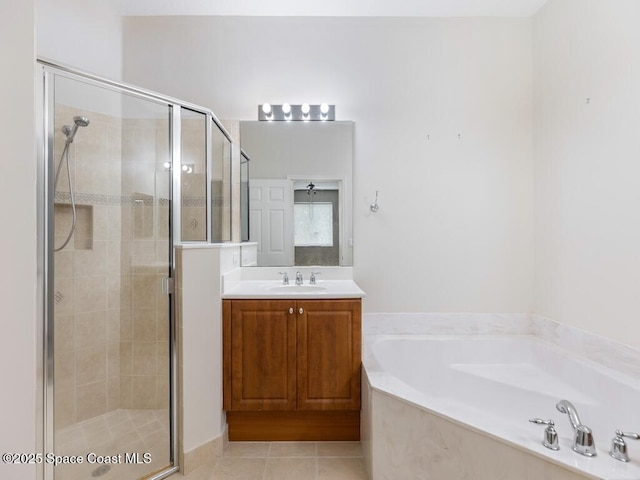 bathroom featuring tile patterned floors, vanity, and shower with separate bathtub