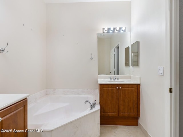 bathroom featuring vanity, a tub to relax in, and tile patterned floors