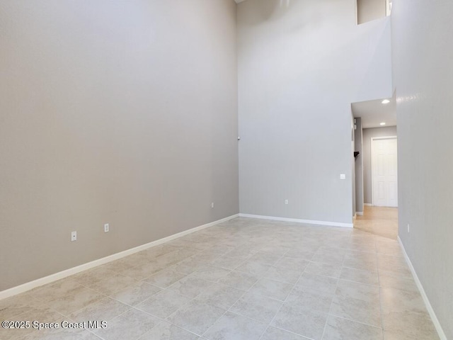 spare room with a towering ceiling